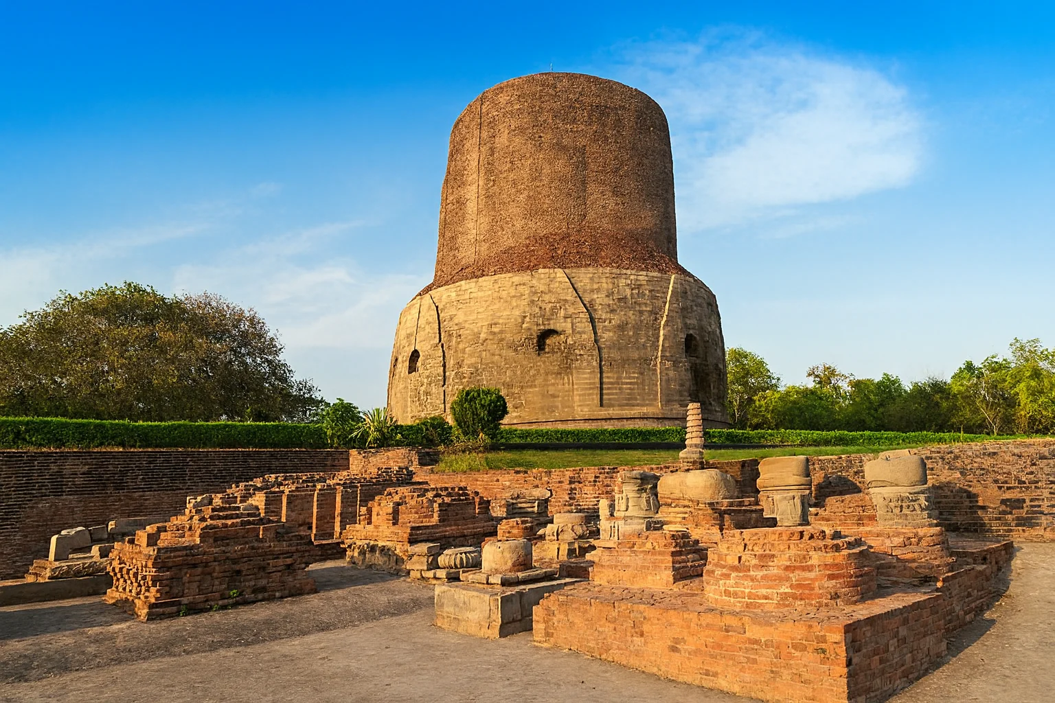 Dhamek Stupa – Ancient Buddhist Monument in Sarnath Dhamek Stupa at Sarnath surrounded by ancient ruins under clear blue sky