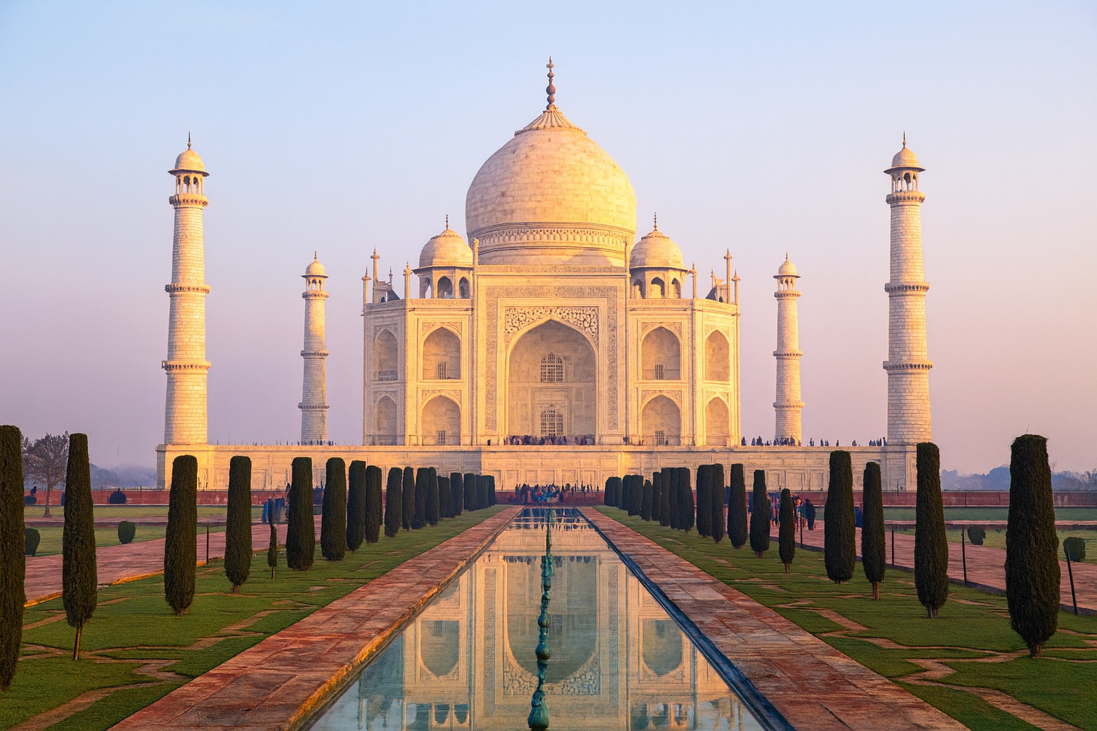 Taj Mahal, Agra — sunrise reflection over the central pool Taj Mahal, Agra — white-marble mausoleum reflected in the central pool at sunrise.