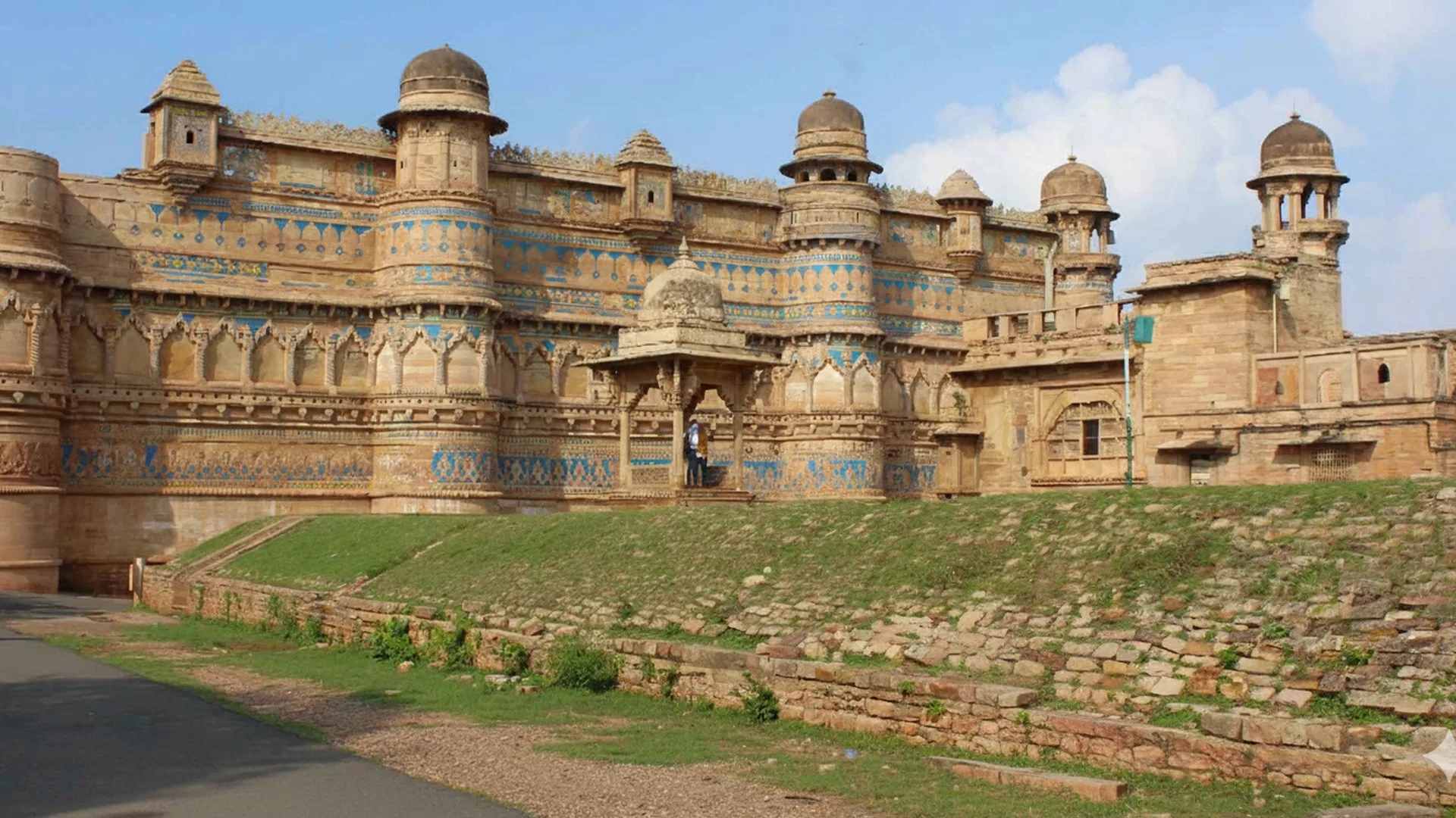 Gwalior Fort – Ancient Hilltop Fortress of Madhya Pradesh, India “Gwalior Fort, majestic hilltop fortress in Madhya Pradesh, India, showcasing Rajput architecture with sandstone walls and blue tile ornamentation