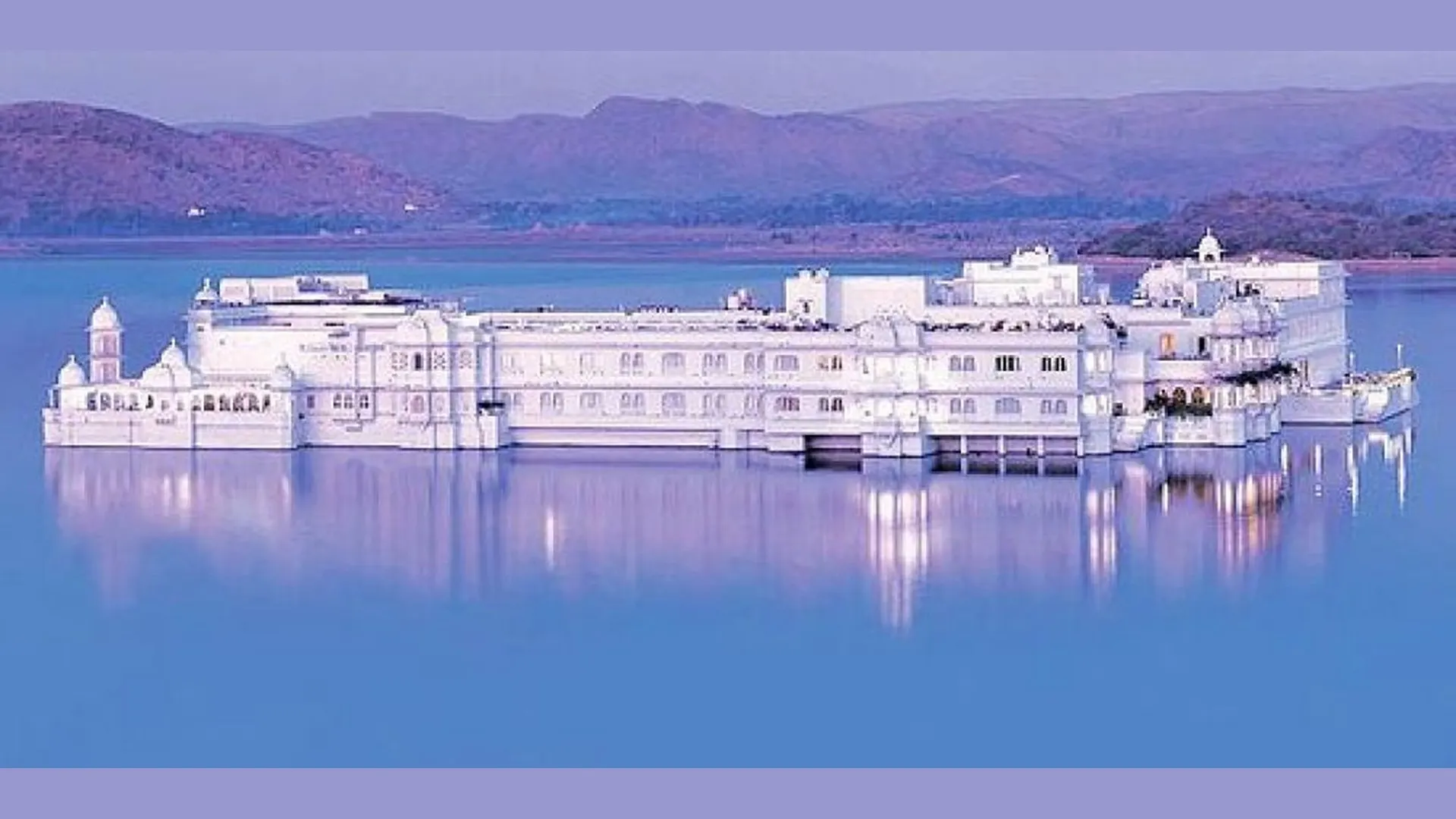 Lake Palace (Jag Niwas), Udaipur The Lake Palace, Udaipur, floating on Lake Pichola at dusk with violet reflections on the water.