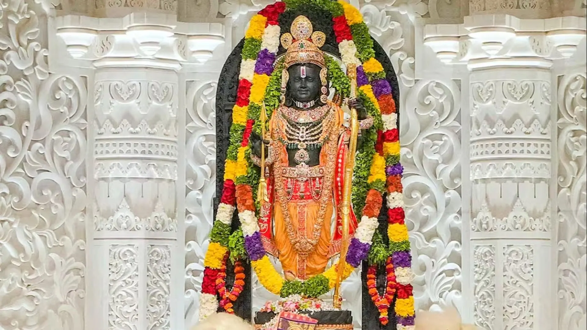 Ram idol, Shri Ram Janmabhumi Ayodhya Ram idol at Shri Ram Janmabhoomi, Ayodhya — ornately dressed statue framed by carved white temple pillars and colourful garlands.