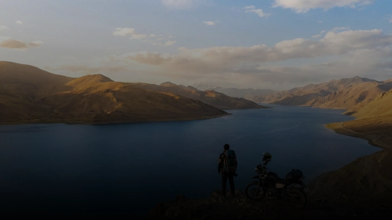 Ladakh Bike Trip A Journey To Find Yourself Ladakh bike trip solo rider overlooking blue high altitude lake.