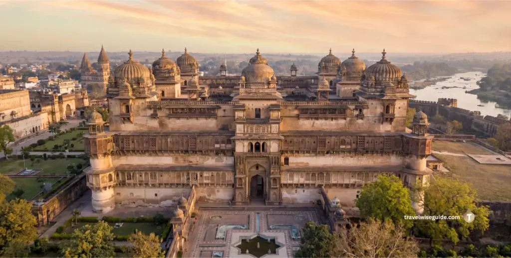 Orchha Palace: Timeless Architectural Splendour Jahangir Mahal with domed chhatris and geometric pond at sunrise.
