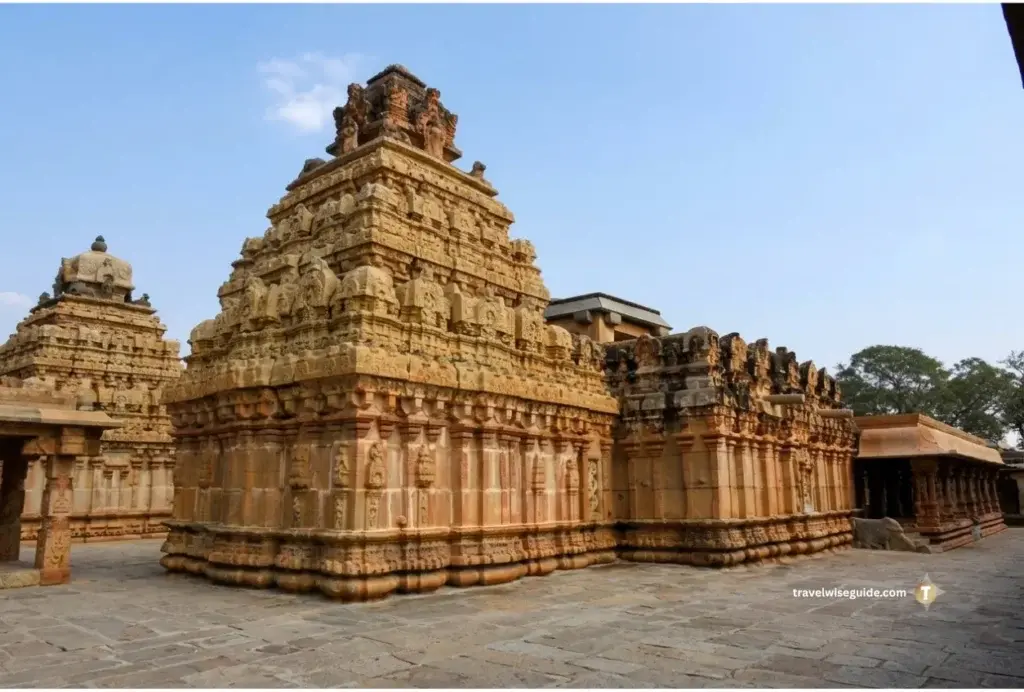 Bhoga Nandeeshwara: Timeless Dravidian Splendour) Stone temple complex showcasing carved tiered towers in open courtyard.