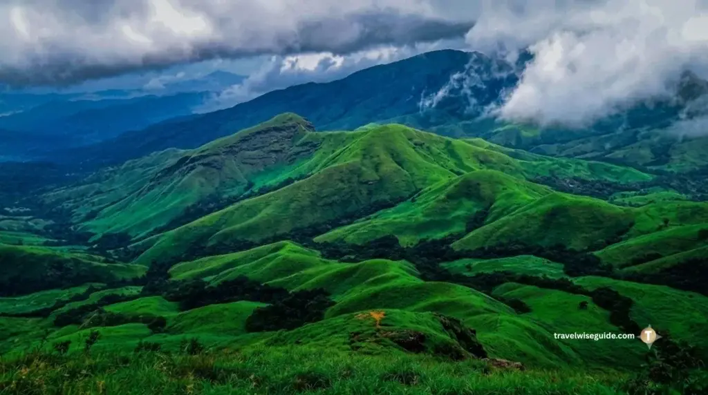 Kudremukh Peak: Unravelling the Emerald Wilderness of Karnataka Kudremukh trek rolling green hills under cloudy Western Ghats sky.