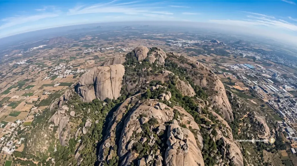 Savandurga: One of Asia’s Largest Monoliths Beckons Aerial view of Savandurga showing a massive granite hill and surrounding plain.